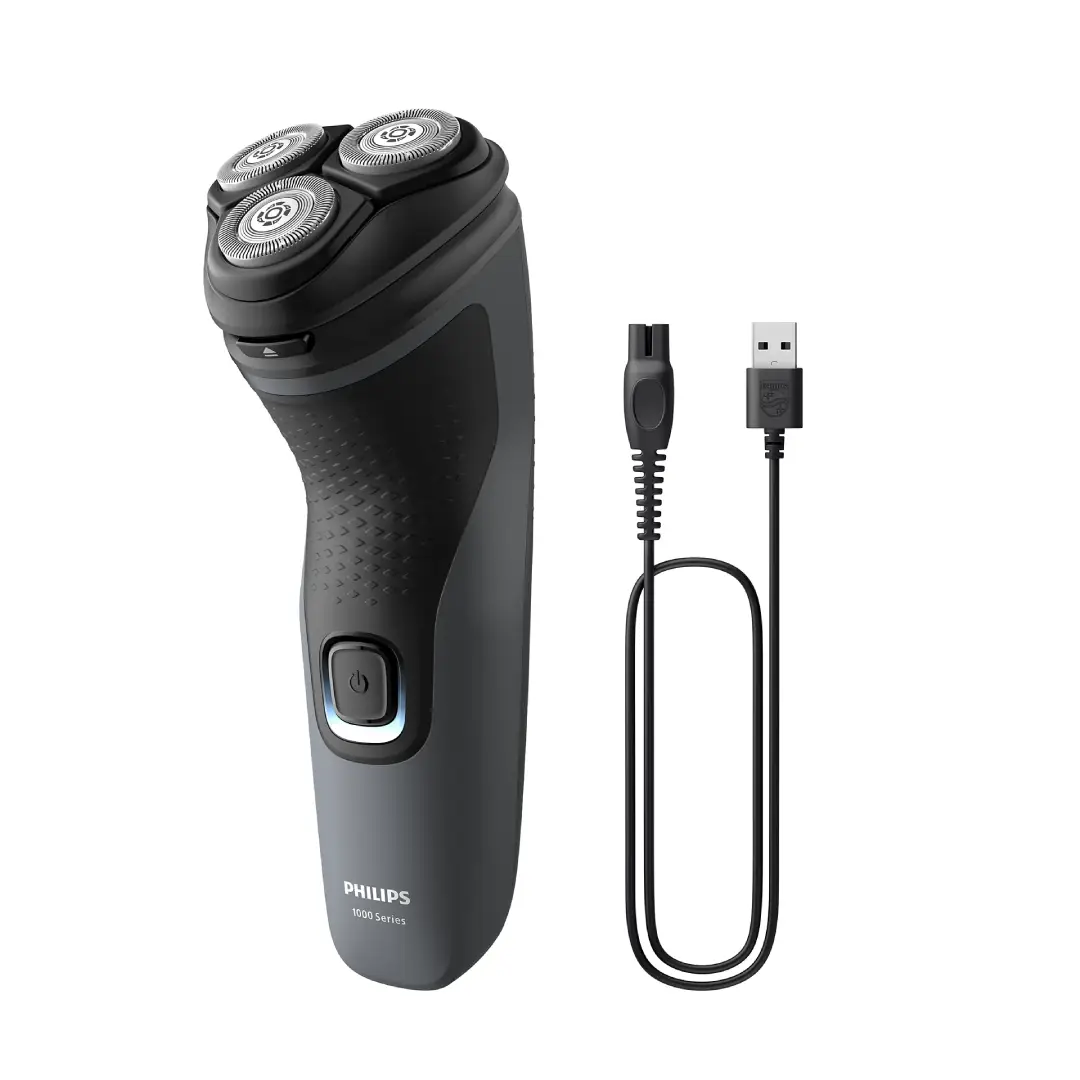 Vista de la afeitadora Philips S-1142/00 junto a su cable USB, lista para cargar