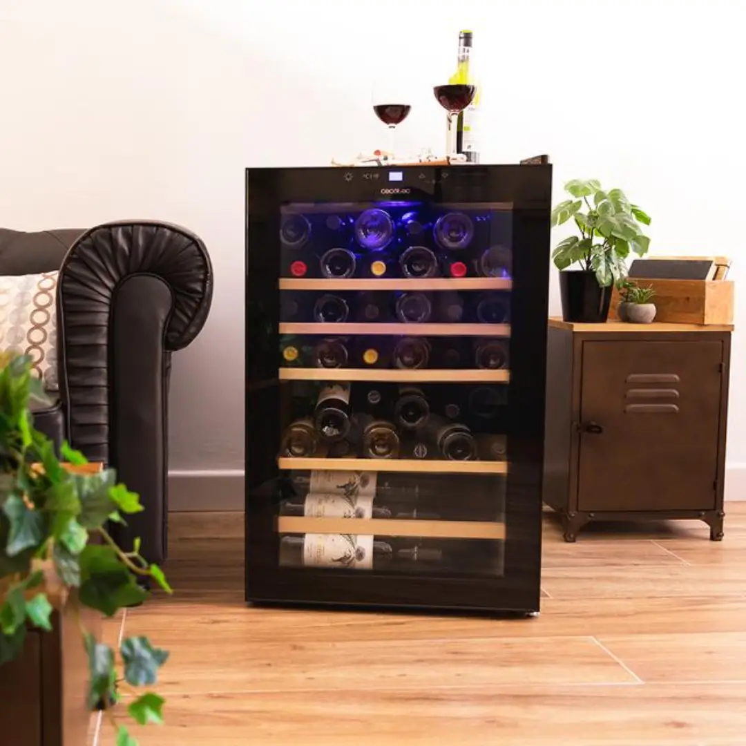 Vinoteca Cecotec GrandSommelier 4850 Black Compressor instalada en una cocina moderna, destacando su acabado negro brillante, puerta de cristal templado, panel táctil LED superior y diseño sofisticado que combina con cualquier ambiente – disponible en Electrocash.