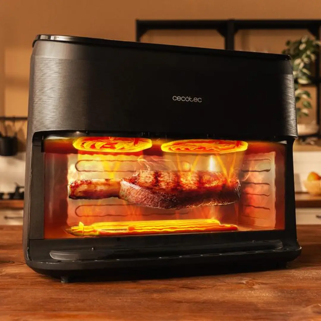Cecofry & Grill Smokin’ 11000 de Cecotec colocada sobre una encimera de cocina, mostrando su diseño elegante, panel táctil digital y el ahumador en funcionamiento, ideal para preparar carnes, pescados o verduras saludables — disponible en Electrocash.